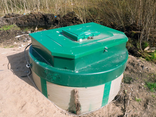 An aerobic waste water treatment system with a green lid.