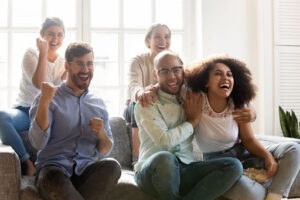 A group of friends having a sports watch party at home.