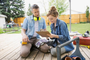 A man and a woman planning a backyard renovation.