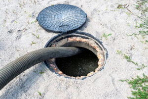 A pipe inserted into a home septic tank for a septic tank pumping service.
