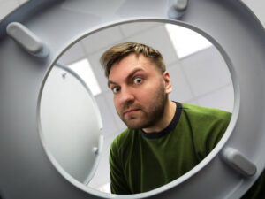 A man looking into a toilet bowl.